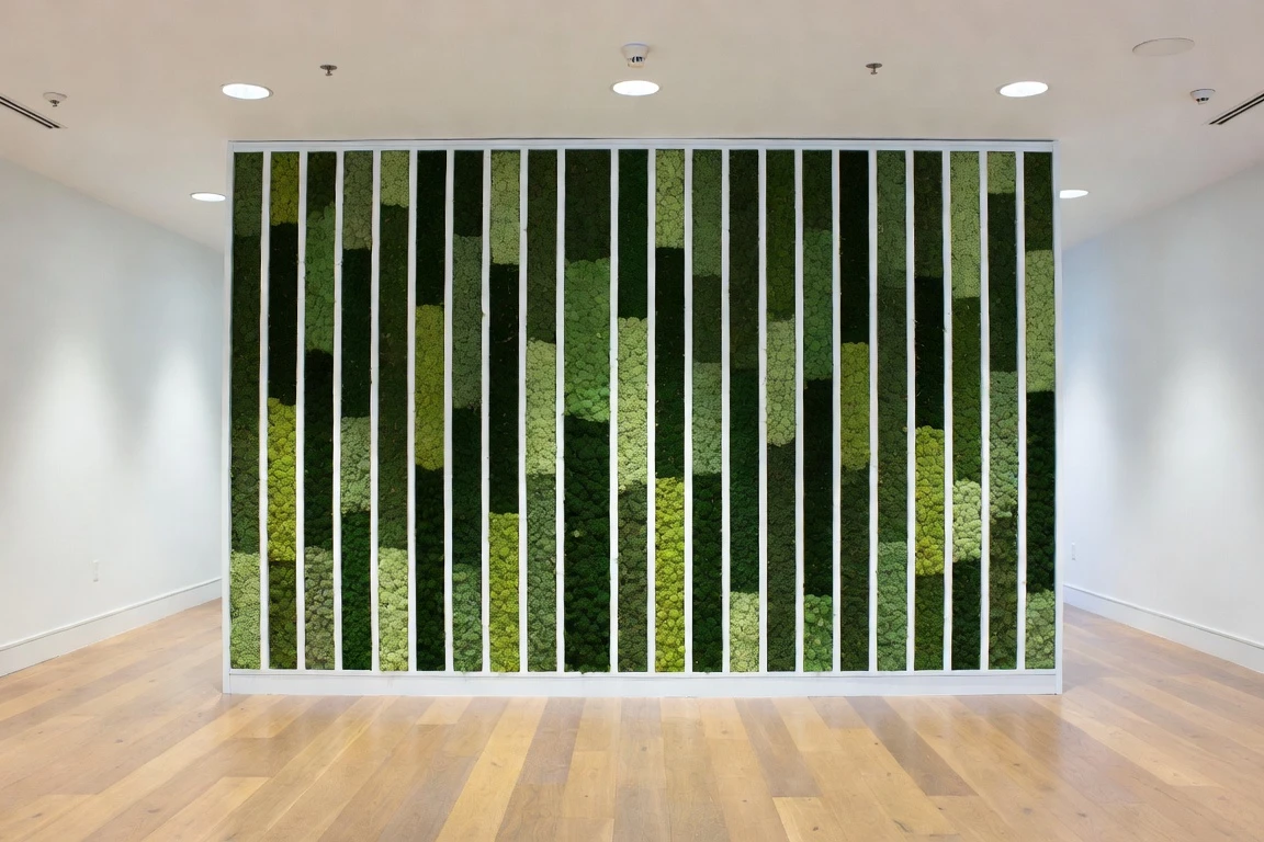Architectural moss wall divided by slender white vertical fins